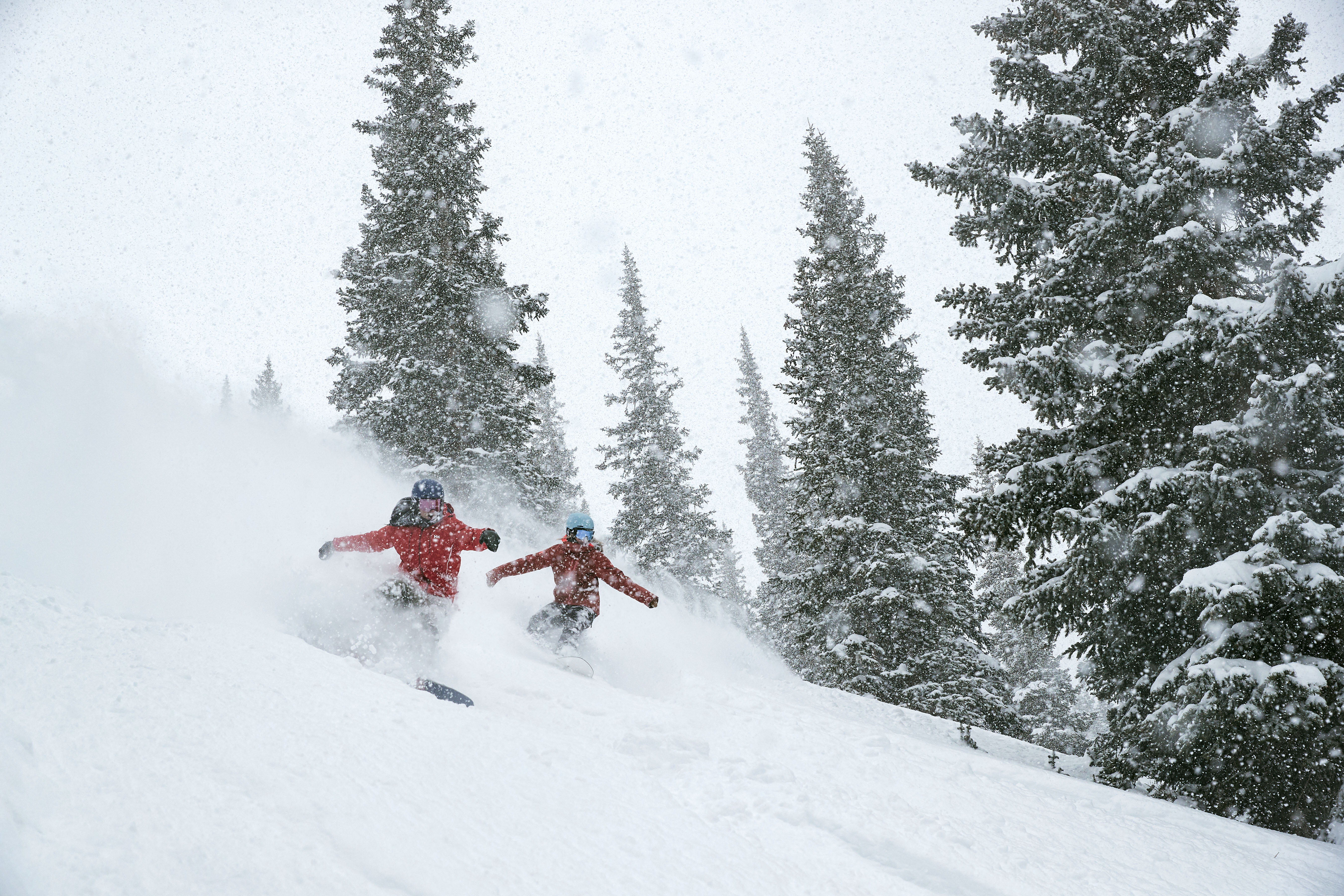 Friends slash powder in the trees at Breck